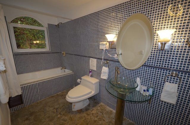 guest bathroom with tile-covered wall