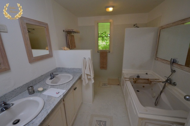 A guest suite bathroom with bath tub