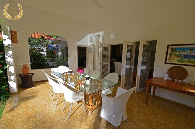 White chairs in dining table under the veranda