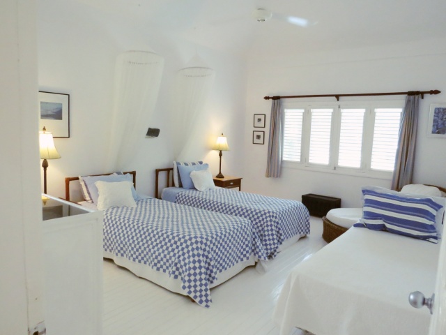 bedroom in white with twin beds